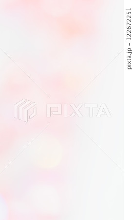 薄いピンク色グラデーションのふんわり背景 パステル玉ボケの写真素材