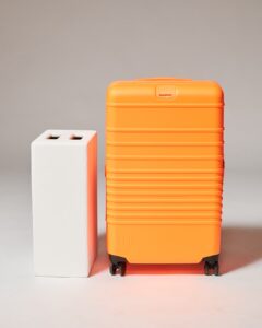 TL207 Curtis Orange 29” Medium Rolling Suitcase Prop Rental - ACME