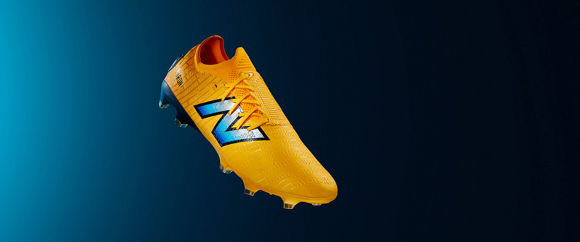 New Balance Furon V7+ Pro Firm Ground - Orange/Blue - Adult Boots