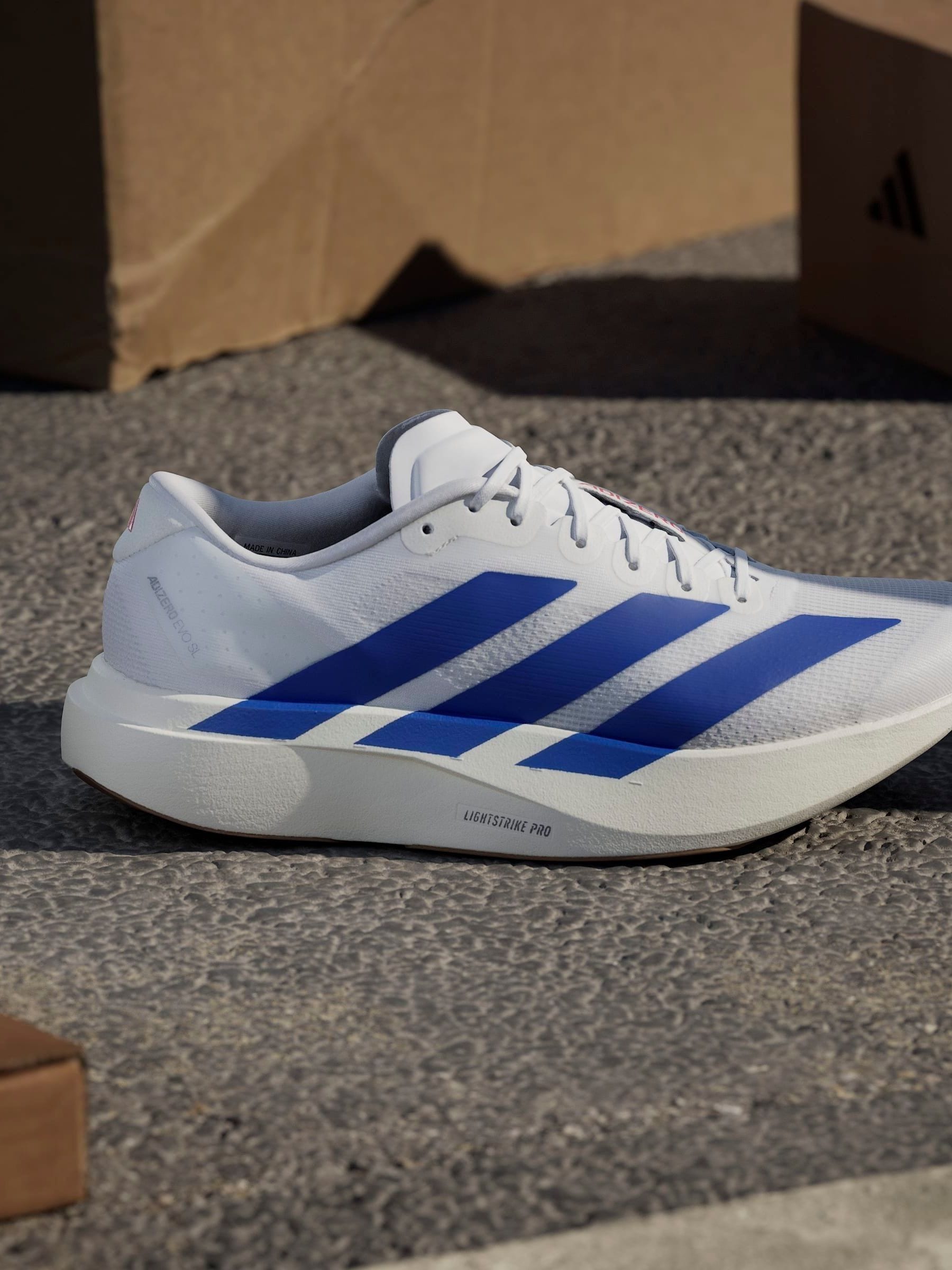 Buy adidas White/Blue Adizero EVO SL Trainers from Next USA