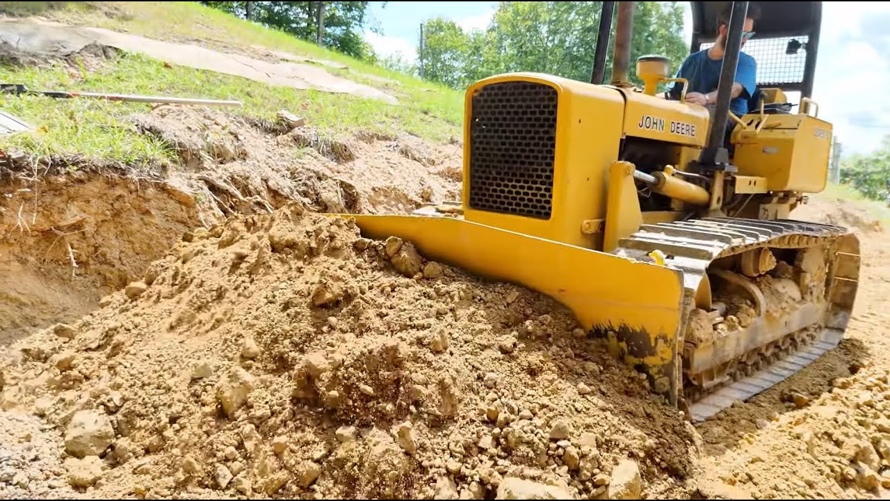 Pushing Dirt with a classic JD 450B Dozer. HARD clay and RAW dozer